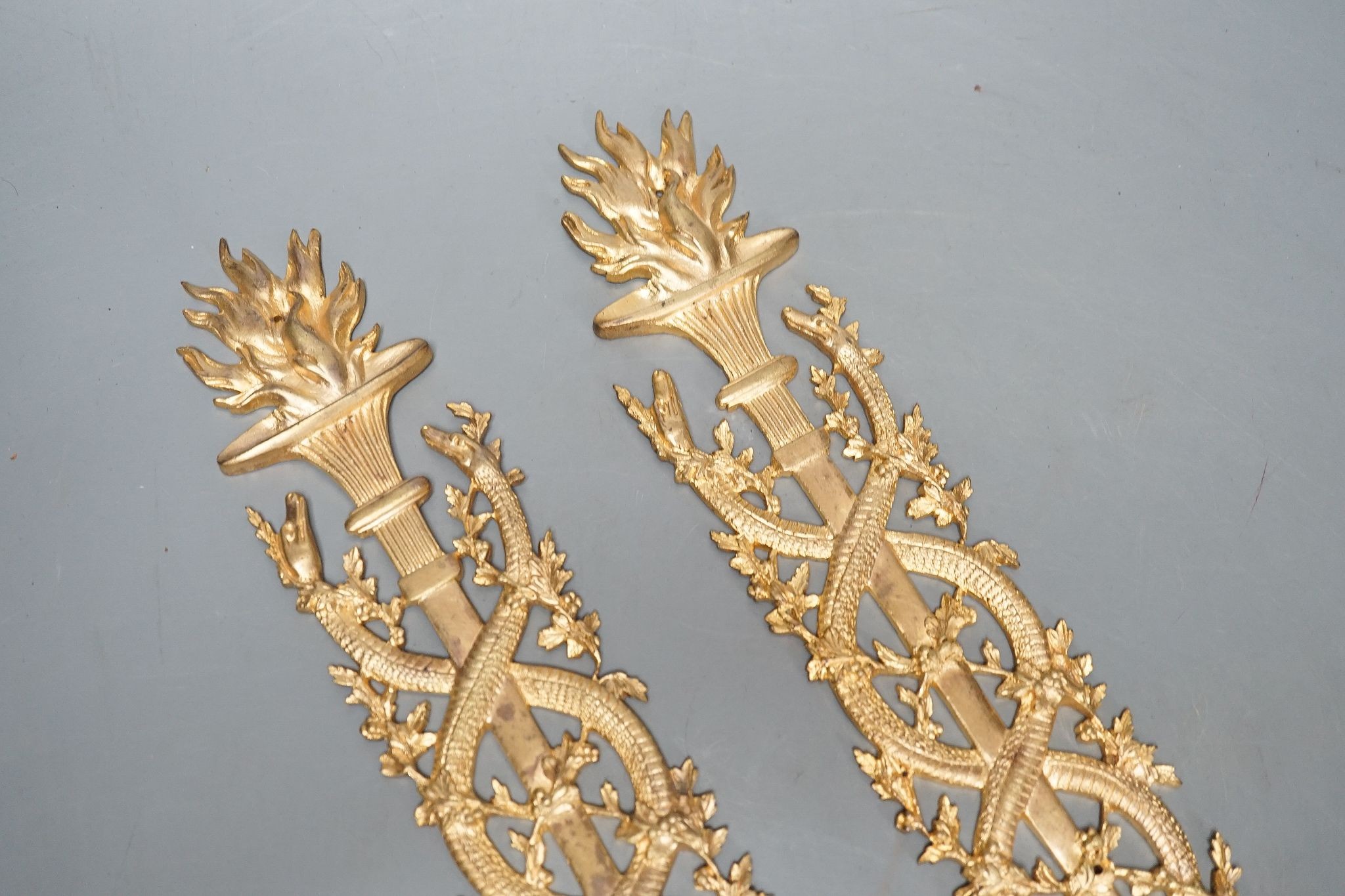 A pair of ormolu furniture mounts, circa 1900, 48cm long